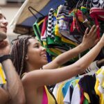 Tourist couple browsing market stall, Copacabana town, Rio De Janeiro, Brazil